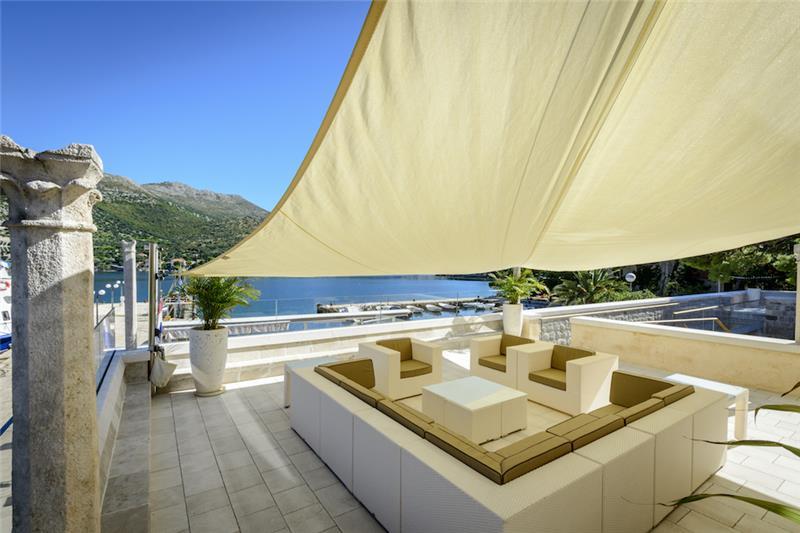 A shaded terrace over the bay at a seaside villa