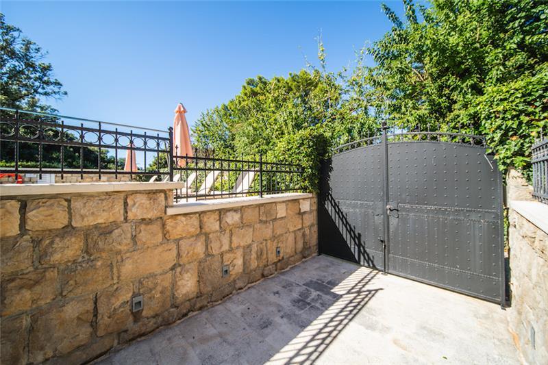 Riveted iron entrance gates in a stone wall at a villa near Dubrovnik