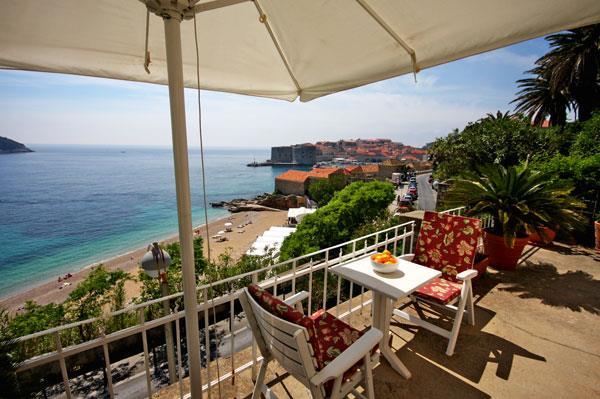 A terrace above Banje beach, Dubrovnik old town behind