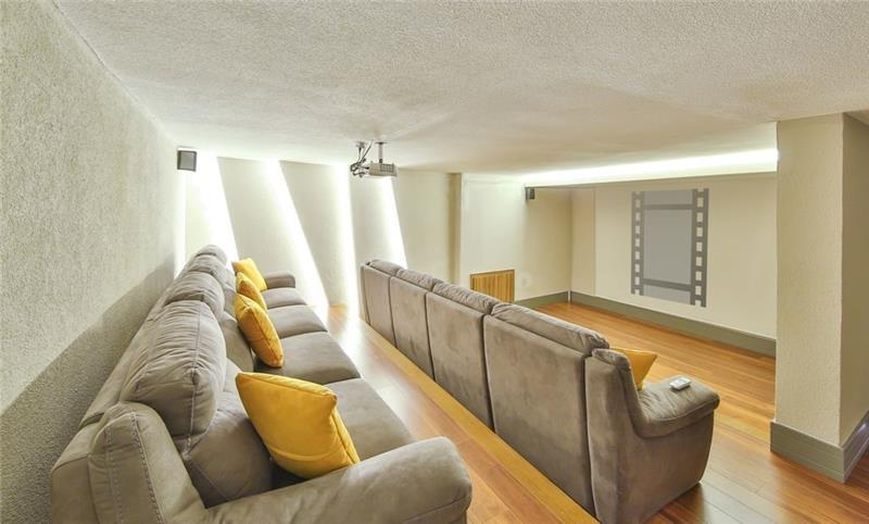 A private cinema room with a projector and deep sofas at a villa in Kalkan