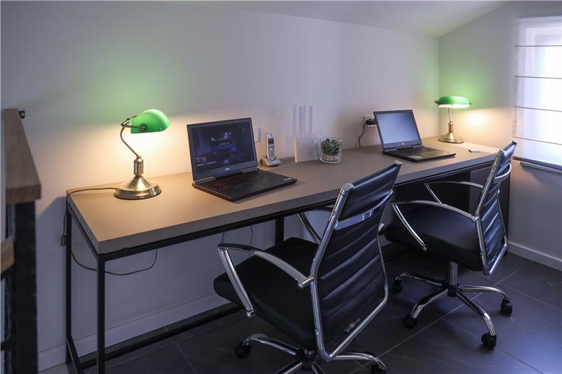 A study set up with two desks, laptops and lamps at a villa in Oprtalj, Istria