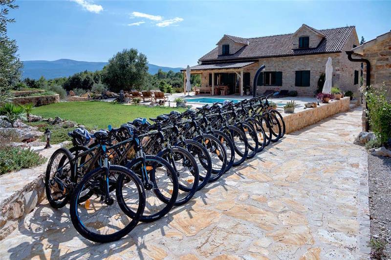A row of bicycles lined up outside a stone farmhouse near Stari Grad, Hvar