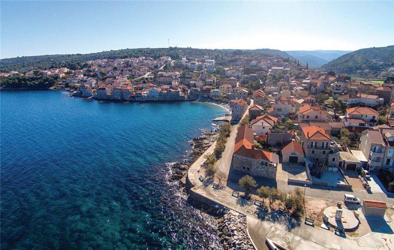 A shore road running along the waterfront of a village on Brač
