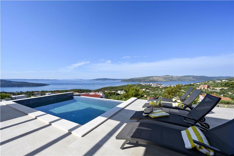 A villa pool and terrace looking over the sea to the islands near Trogir, Croatia