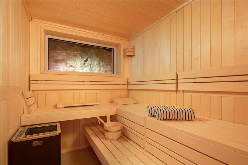A wood-lined sauna with rolled towels at a villa near Sumartin, Brač